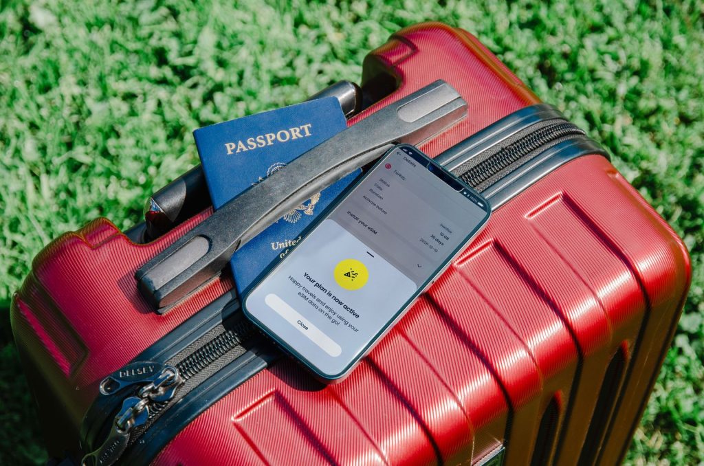 Pasaporte y móvil sobre una maleta lista para viajar