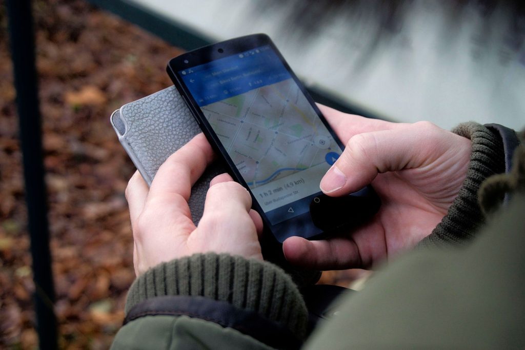 Persona usando el móvil con GPS y datos mientras viaja al extranjero